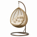 Chaise suspendue en métal avec siège en rotin et coussin beige